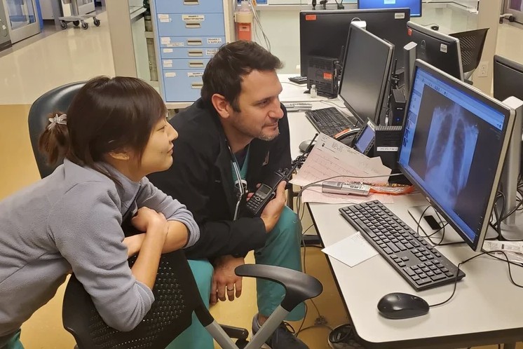 two doctors looking at a computer