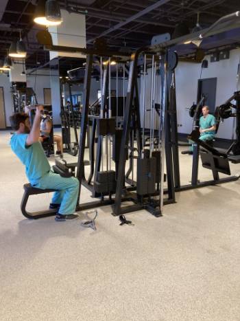 two doctors at the gym in scrubs